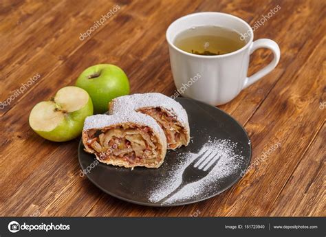 Apple Strudel With Icing Sugar On Black Plate Wooden Background Stock