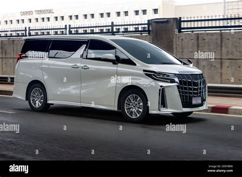 A luxury minivan drives in front of the airport Stock Photo - Alamy