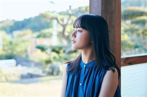 A Woman Standing In Front Of A Window