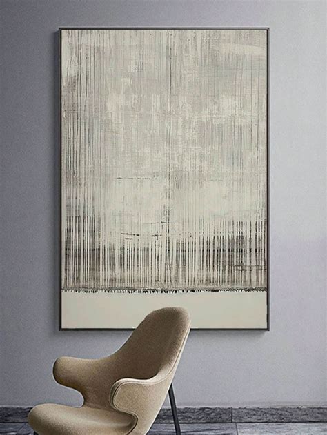 An Abstract Painting Hangs On The Wall Next To A Modern Chair And