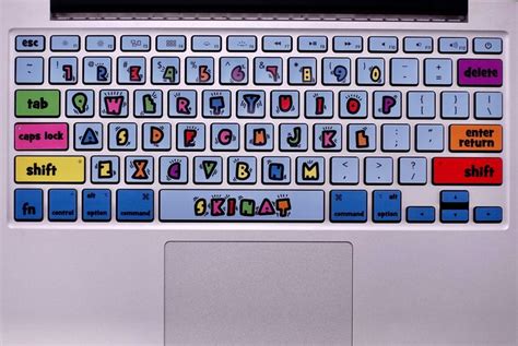 an open laptop computer with colorful stickers on the keyboard and ...