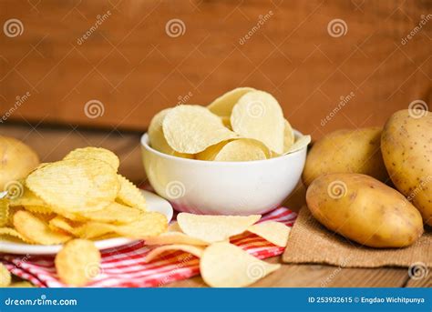 Potato Chips Snack On White Bowl Crispy Potato Chips On The Table Food And Fresh Raw Potatoes