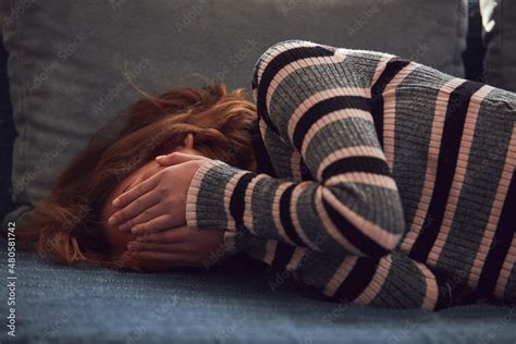 Teenage girl being upset and crying at home. Stock Photo | Adobe Stock