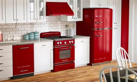 A Red Stove Top Oven Sitting Inside Of A Kitchen Next To A White