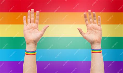 Premium Photo Hands With Gay Pride Rainbow Wristbands