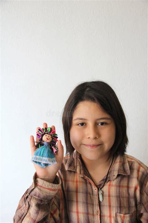 10 Year Old Hispanic Latina Girl Shows Her Favorite Toy And Dessert In The Form Of A Traditional