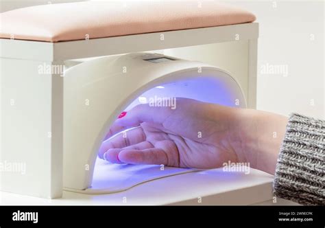 Woman S Hand In UV Lamp Process Of Drying Gel Polish Manicure Process