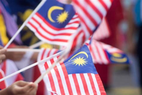 Hand Waving Malaysia Flag Also Known As Jalur Gemilang In Conjunction