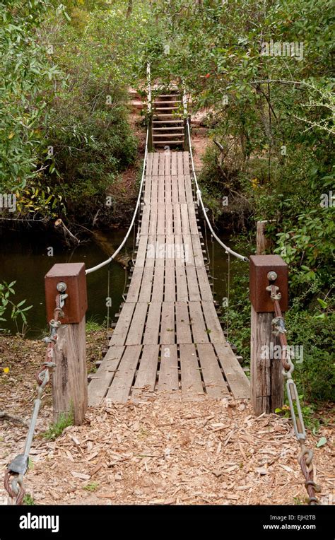 Wooden Suspension Bridge Across A Stream Stock Photo Alamy