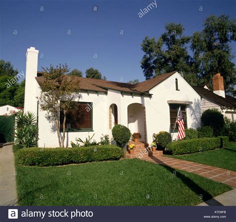 white stucco house with brown trim - Shanice Renner