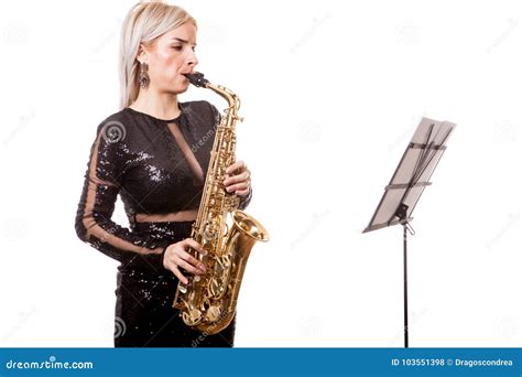 Attractive Saxophonist Woman Playing At Her Musical Instrument Stock