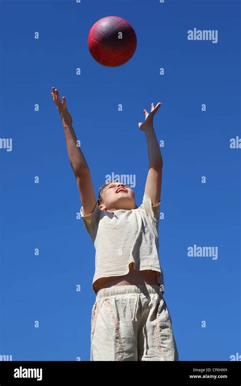 Boy carrom ball upwards and catches him Stock Photo - Alamy