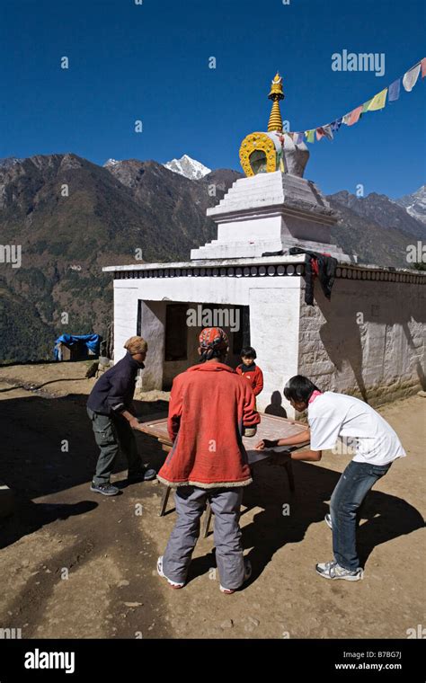 Nepali kids playing karom board game in Lukla village Khumbu area Nepal ...