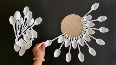 Spoons Are Arranged In The Shape Of A Sunburst On A Black Surface