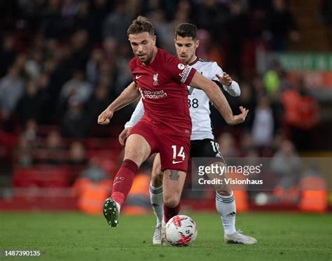 Jordan Henderson Of Liverpool And Manor Solomon Of Fulham In Action