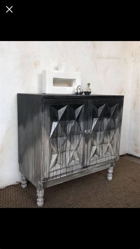 An Old Metal Cabinet With Glass Doors And Legs On The Bottom In Front