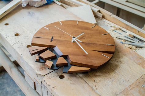 a clock made out of pieces of wood sitting on top of a workbench