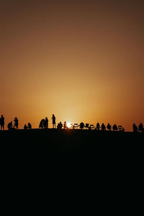 People Silhouette at Sunset under Clear Sky · Free Stock Photo