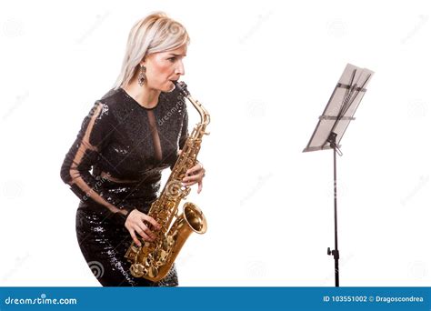 Attractive Saxophonist Woman Playing At Her Musical Instrument Stock