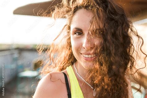 Outside Close Up Portrait Of Adorable European Woman With Wavy Hair And Nude Make Up In Sunlight