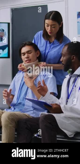 Vertical Video Medical Staff Helping Injured Patient To Take Off