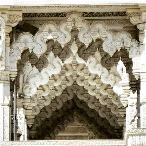 An Intricately Decorated Building With Columns And Arches