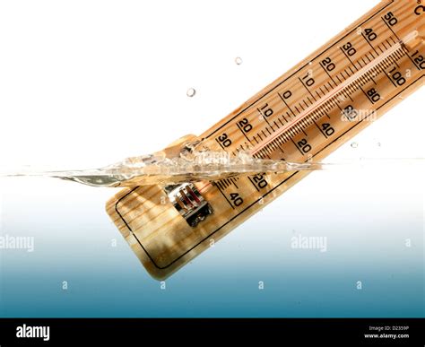 Thermometer measures the temperature of the water Stock Photo - Alamy