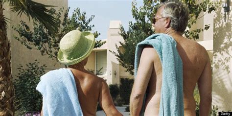 An Older Man And Woman Holding Hands While Wrapped In Towels