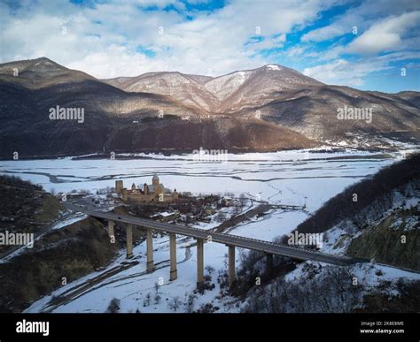 Ananuricastle complex on the Aragvi River in Georgia next to viaduct bridge. Snowy winter ...