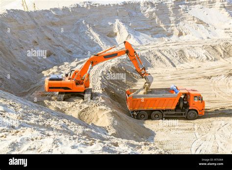 Work Of The Excavator And Truck At A Sand Quarry Excavator Loading