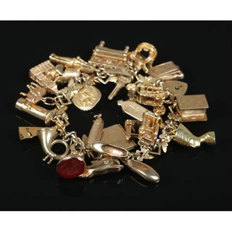 A 9ct Gold Charm Bracelet With Floral And Paste Set Links And Contents