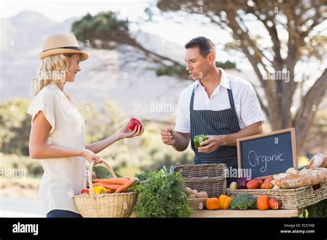 Smiling Farmer Discussing With A Blonde Customer Stock Photo Alamy
