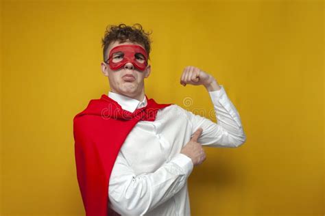 Confident Guy in a Superhero Costume Shows the Muscles on His Arm, the ...