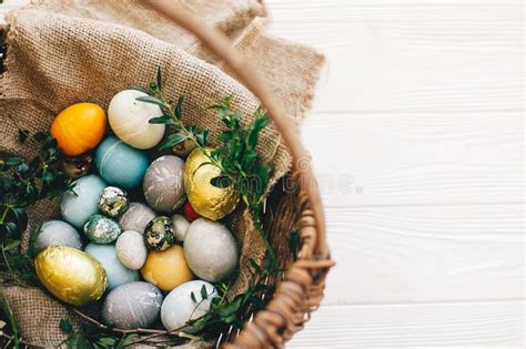 Happy Easter Stylish Easter Eggs In Rustic Basket On White Wooden