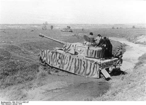 Panzer IV Ausf. J, with armor aprons and camouflage paint, on the move ...