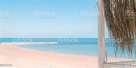 Massage Huts With Thatched Roof On Sand Beach Along Seaside Luxury