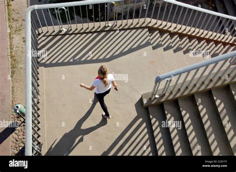 Girl Setting Of Downstairs Stairs Railings Sunlight And Shadows Stock