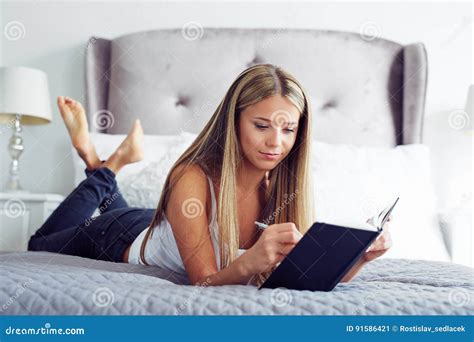 Young Woman Lying In Bed With Diary Stock Image Image Of White Woman