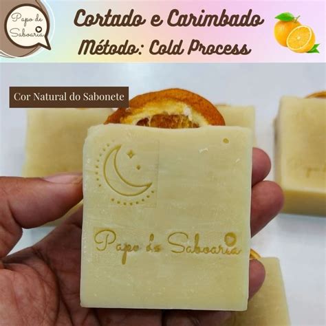 A Hand Holding A Bar Of Soap With An Orange Slice In It S Center