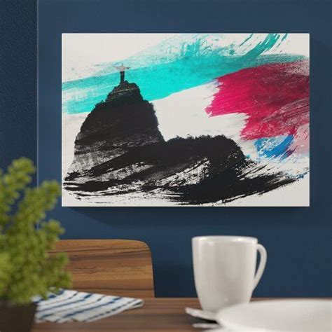 A Painting On The Wall Above A Table With A Cup And Saucer Next To It