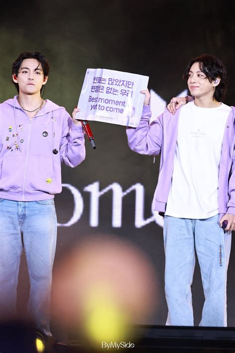 Taekook Holding A Banner That Says Best Moment Is Yet To Come During