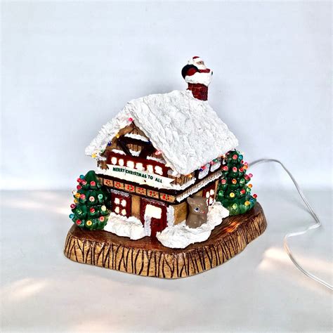 A Lighted Ceramic Christmas House With Wood Base Handmade