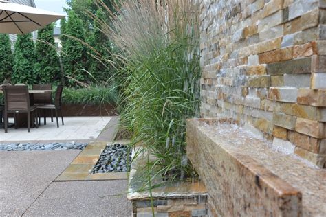 A Pair Of Contemporary Water Walls With Karl Foerster Grasses Planted Between Water Walls