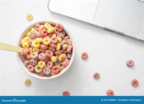 Healthy Food Concept Colorful Ring Cereals In Bowl For Breakfast Meal And Working On Laptop