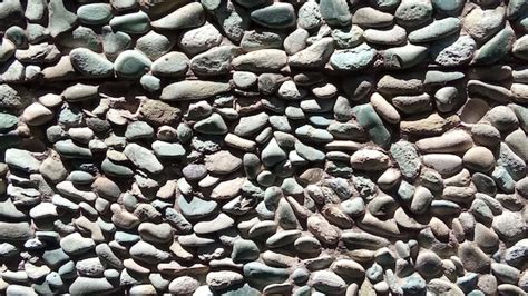 Premium Photo | Wall with small pebble stones