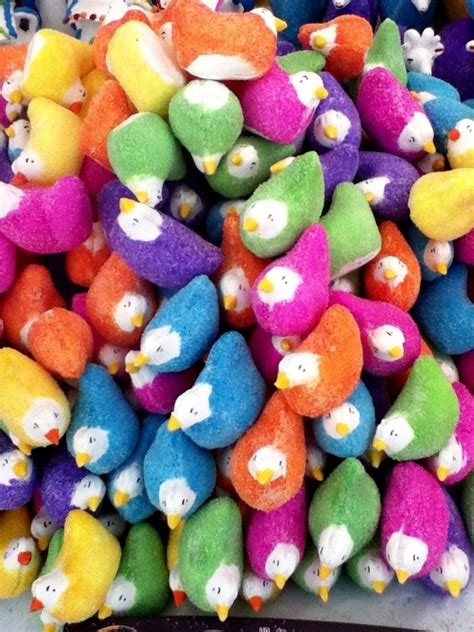 A Pile Of Multicolored Stuffed Birds Sitting Next To Each Other