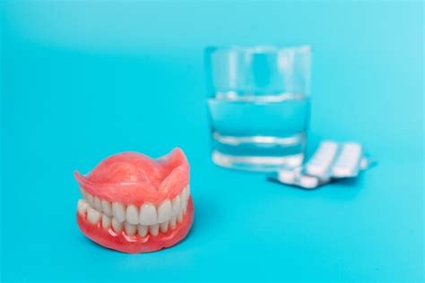 Premium Photo A Prosthesis And A Glass With A Solution Dental