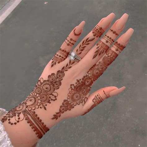 A Woman S Hand With Henna Tattoos On It