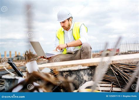 Engineer Planning With Laptop Using Technology At Construction Site