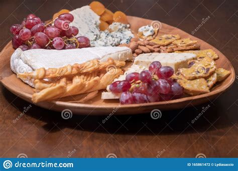 Wooden Cheese Platter with Brie, Assorted Cheeses, Red Grapes, Crackers ...